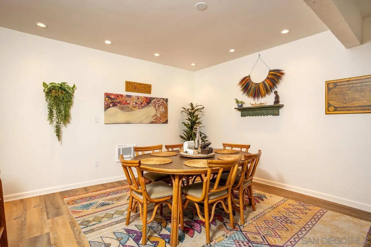 2412 Altisma Way, Unit D Carlsbad, CA 92009 - Photo 15 of 46 a dining room with furniture and wooden floor