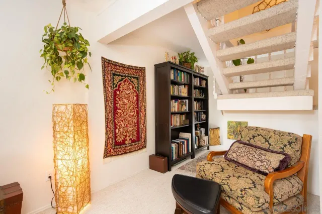 a bedroom with a bed a large window with table and chairs