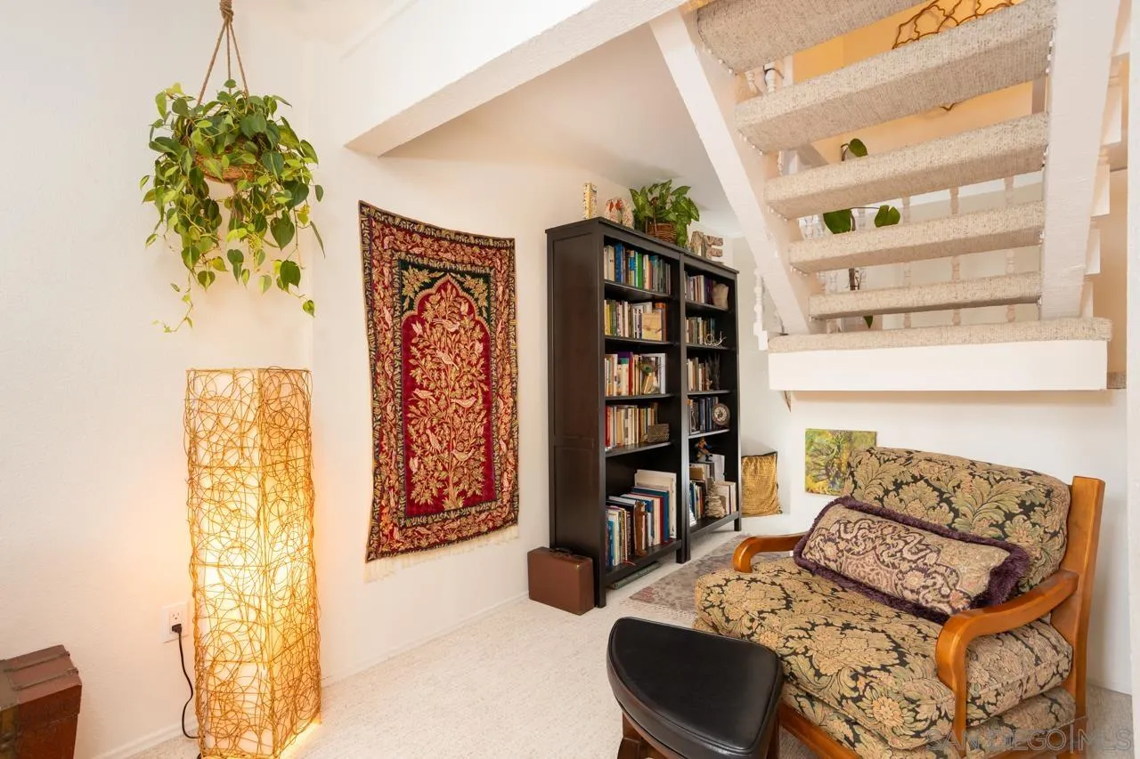 2412 Altisma Way, Unit D Carlsbad, CA 92009 - Photo 24 of 46 a bedroom with furniture and a book shelf
