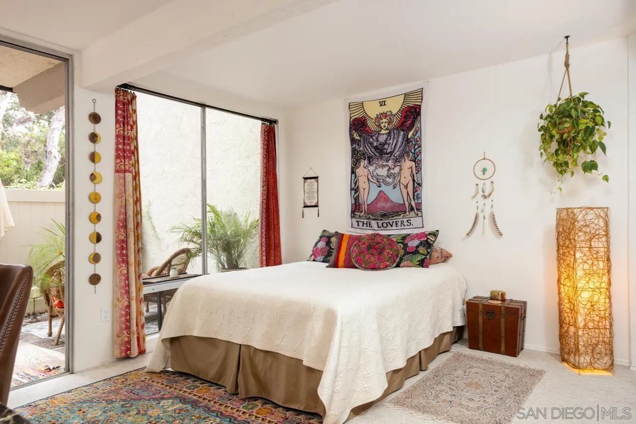 2412 Altisma Way, Unit D Carlsbad, CA 92009 - Photo 25 of 46 a bedroom with a bed and a painting on the wall