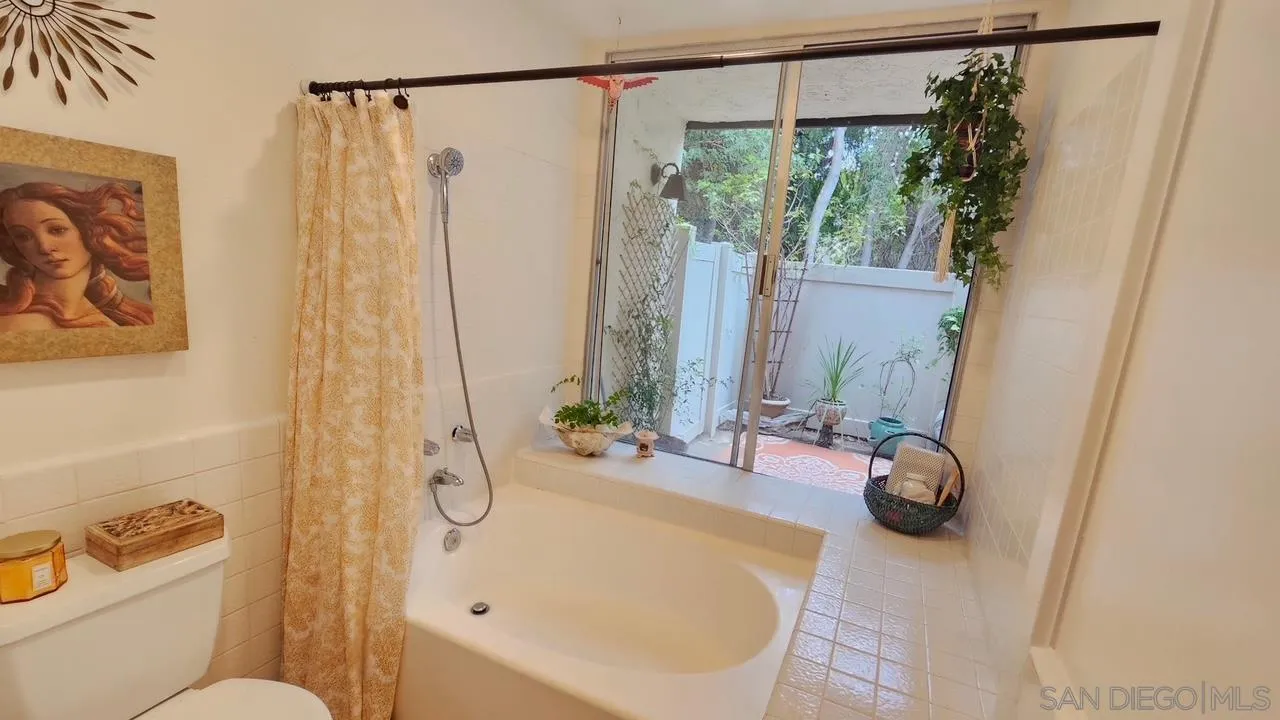 2412 Altisma Way, Unit D Carlsbad, CA 92009 - Photo 28 of 46 a bathroom with a sink and a mirror