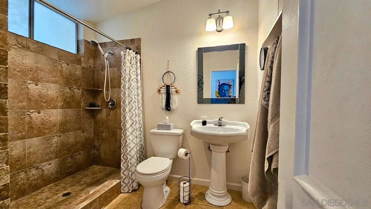 2412 Altisma Way, Unit D Carlsbad, CA 92009 - Photo 33 of 46 a bathroom with a toilet sink and shower