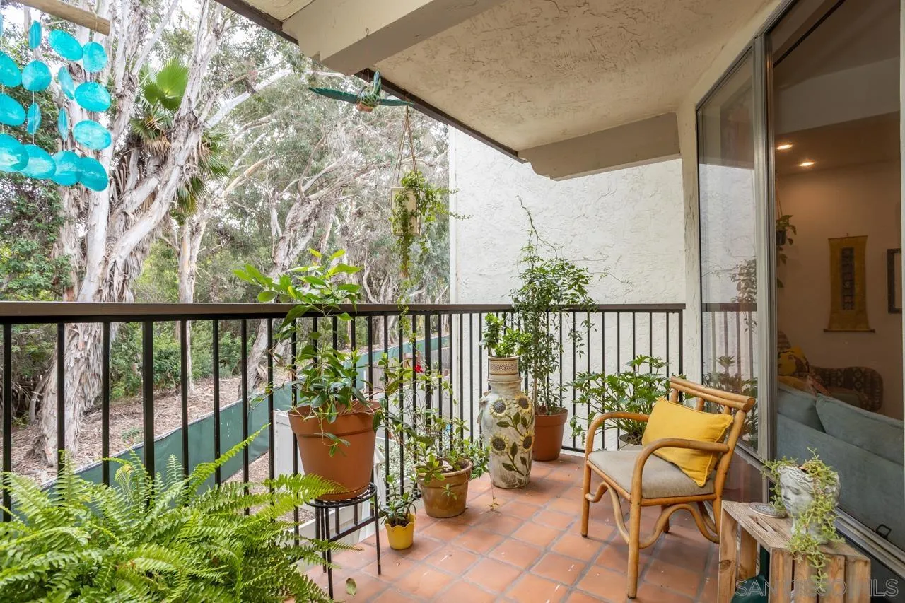 2412 Altisma Way, Unit D Carlsbad, CA 92009 - Photo 9 of 46 a balcony with wooden floor and outdoor seating