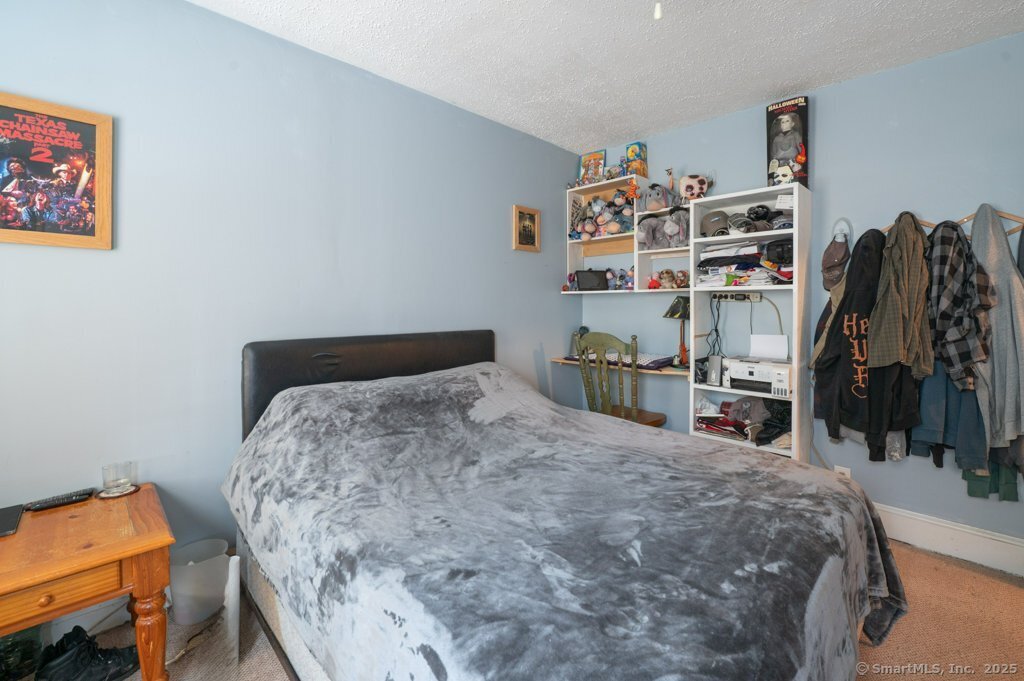 21 Poplar Street Waterbury, CT 06708 - Photo 14 of 31 a bed sitting in a bedroom and room