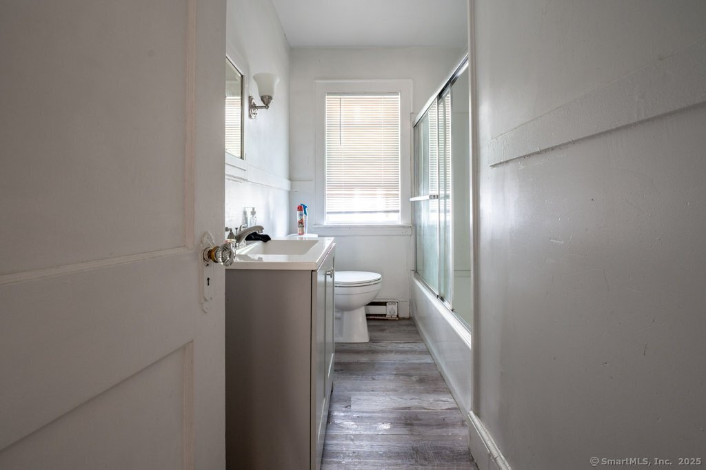 21 Poplar Street Waterbury, CT 06708 - Photo 21 of 31 a bathroom with a sink a toilet and a mirror