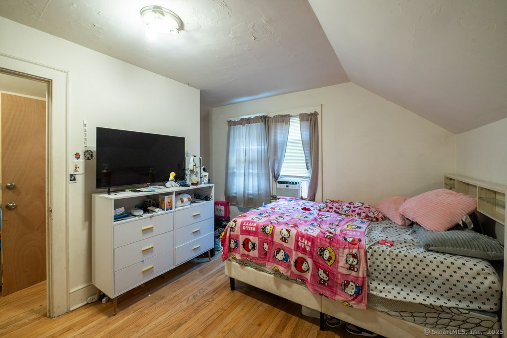 21 Poplar Street Waterbury, CT 06708 - Photo 25 of 31 a bedroom with a bed and a flat screen tv