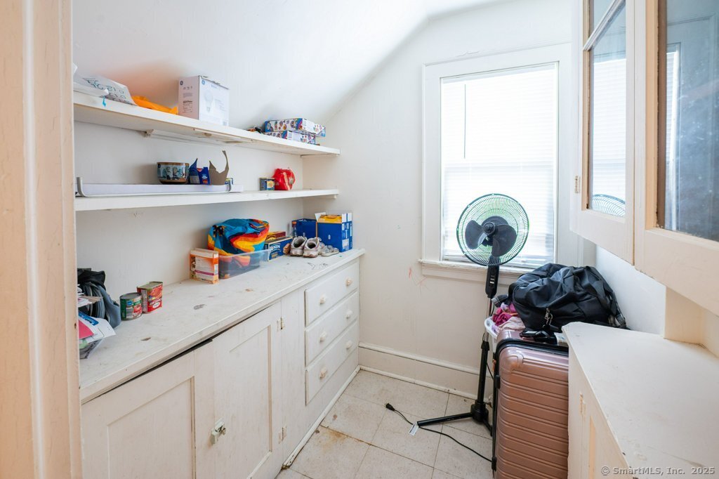 21 Poplar Street Waterbury, CT 06708 - Photo 29 of 31 a kitchen with white cabinets and window