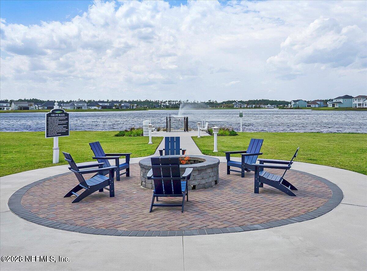 197 Charlie Way St. Augustine, FL 32095 - Photo 29 of 37 an outdoor sitting area with swimming pool and lake view