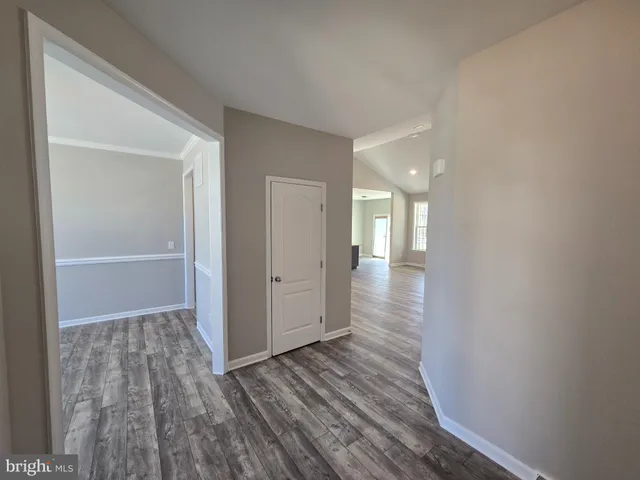 a view of hallway with wooden floor