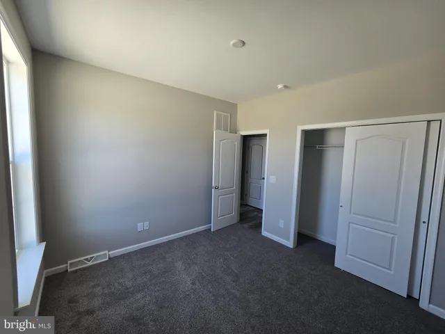 an empty room with closet area