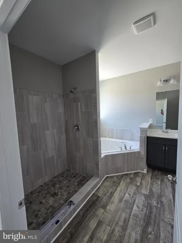 a bathroom with bathtub and shower
