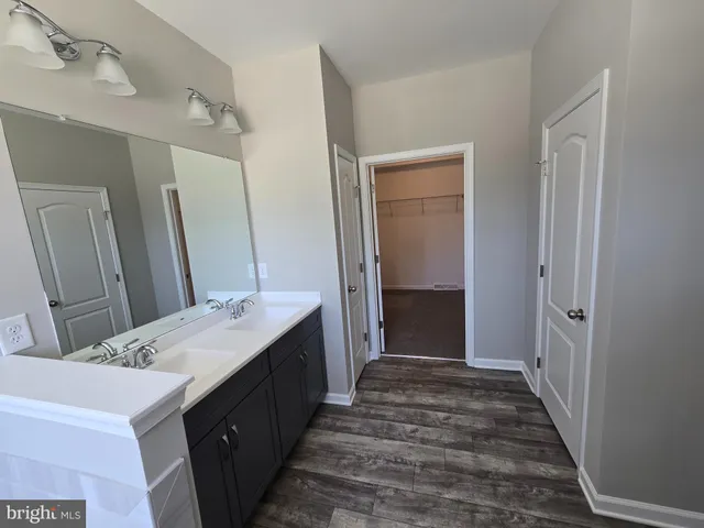 a bathroom with a double vanity sink and a mirror