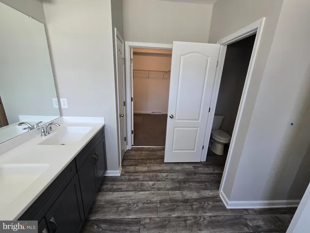 a bathroom with a sink a toilet and mirror