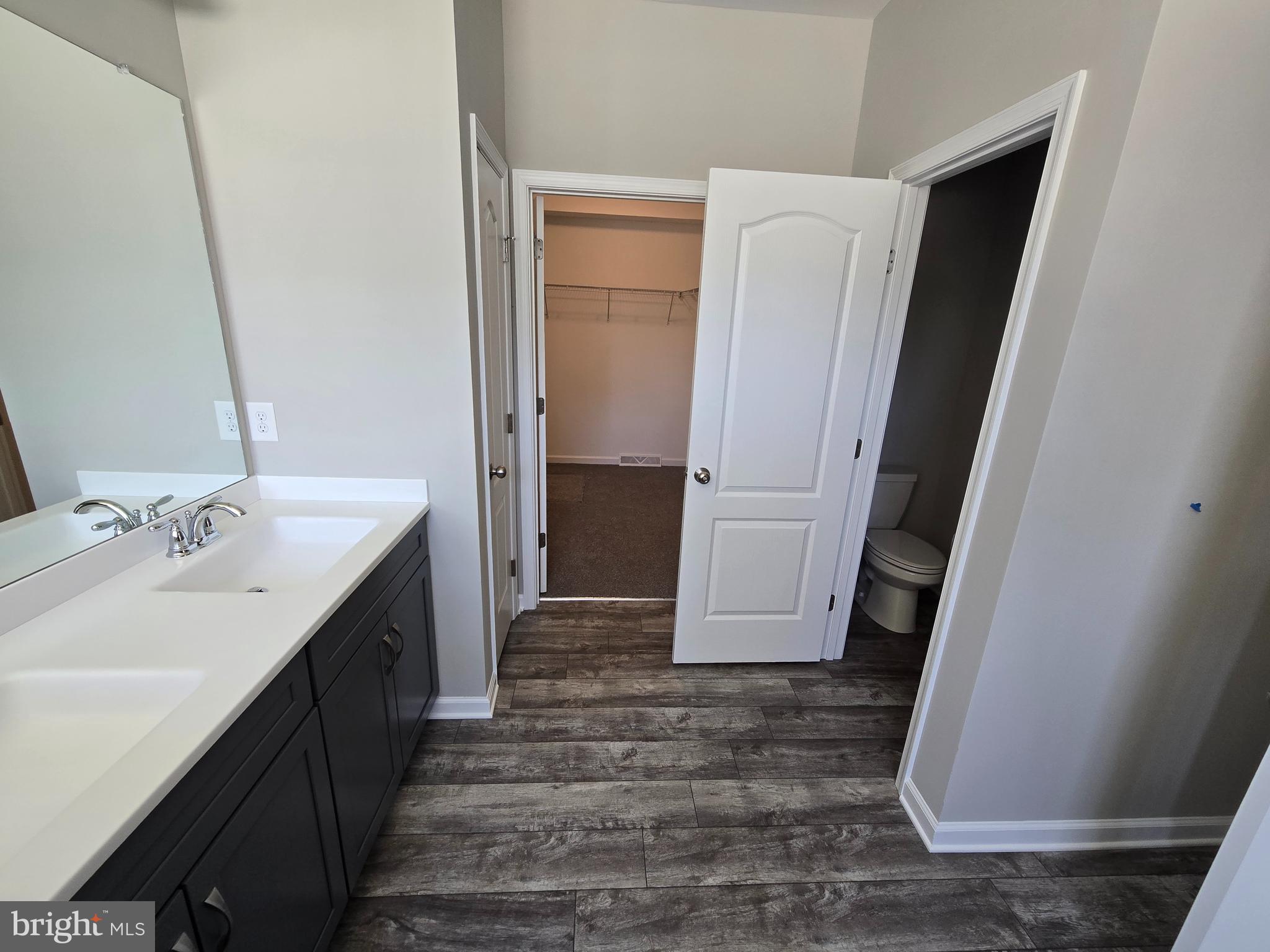 1 William Street Georgetown, DE 19947 - Photo 19 of 34 a bathroom with a sink a toilet and mirror