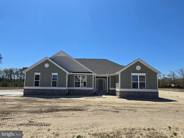 a front view of a house with a garden and yard