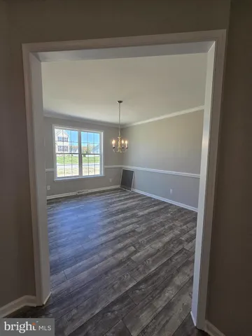 a view of a room with wooden floor and windows