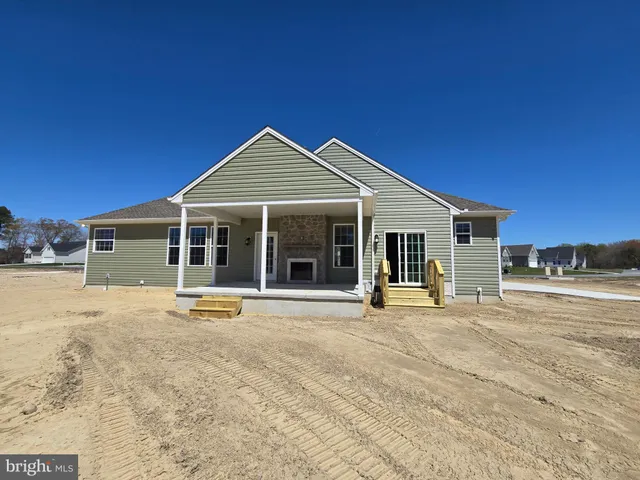 a front view of a house with a yard and seating space