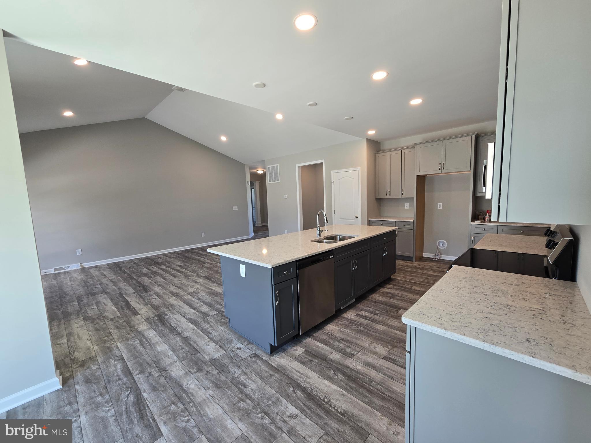 1 William Street Georgetown, DE 19947 - Photo 7 of 34 a large kitchen with stainless steel appliances a large counter top a stove and a refrigerator