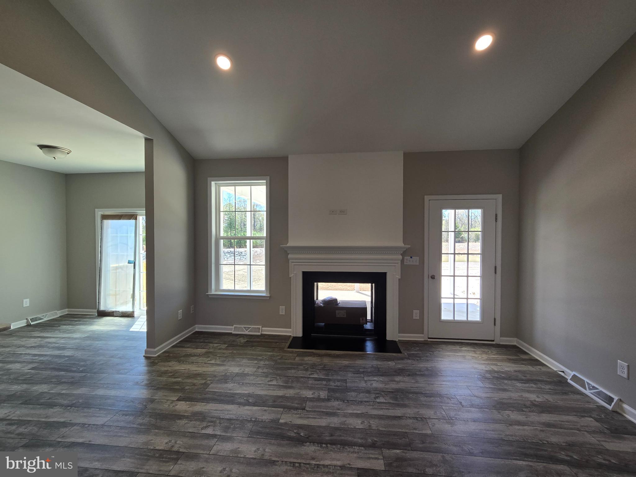 1 William Street Georgetown, DE 19947 - Photo 9 of 34 an empty room with wooden floor and fireplace