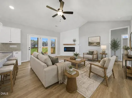 a living room with furniture and a wooden floor