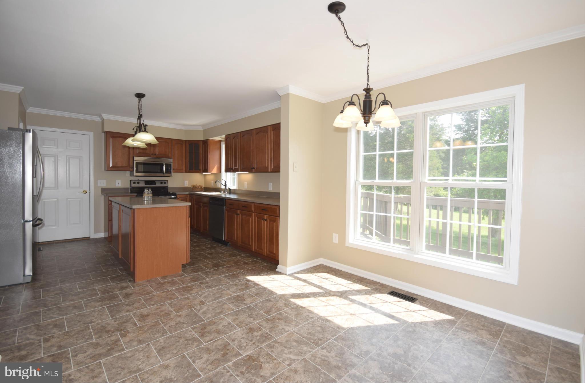 150 High Bluff Road Middletown, VA 22645 - Photo 11 of 30 a open kitchen with stainless steel appliances granite countertop a stove top oven a sink dishwasher a refrigerator and a fireplace