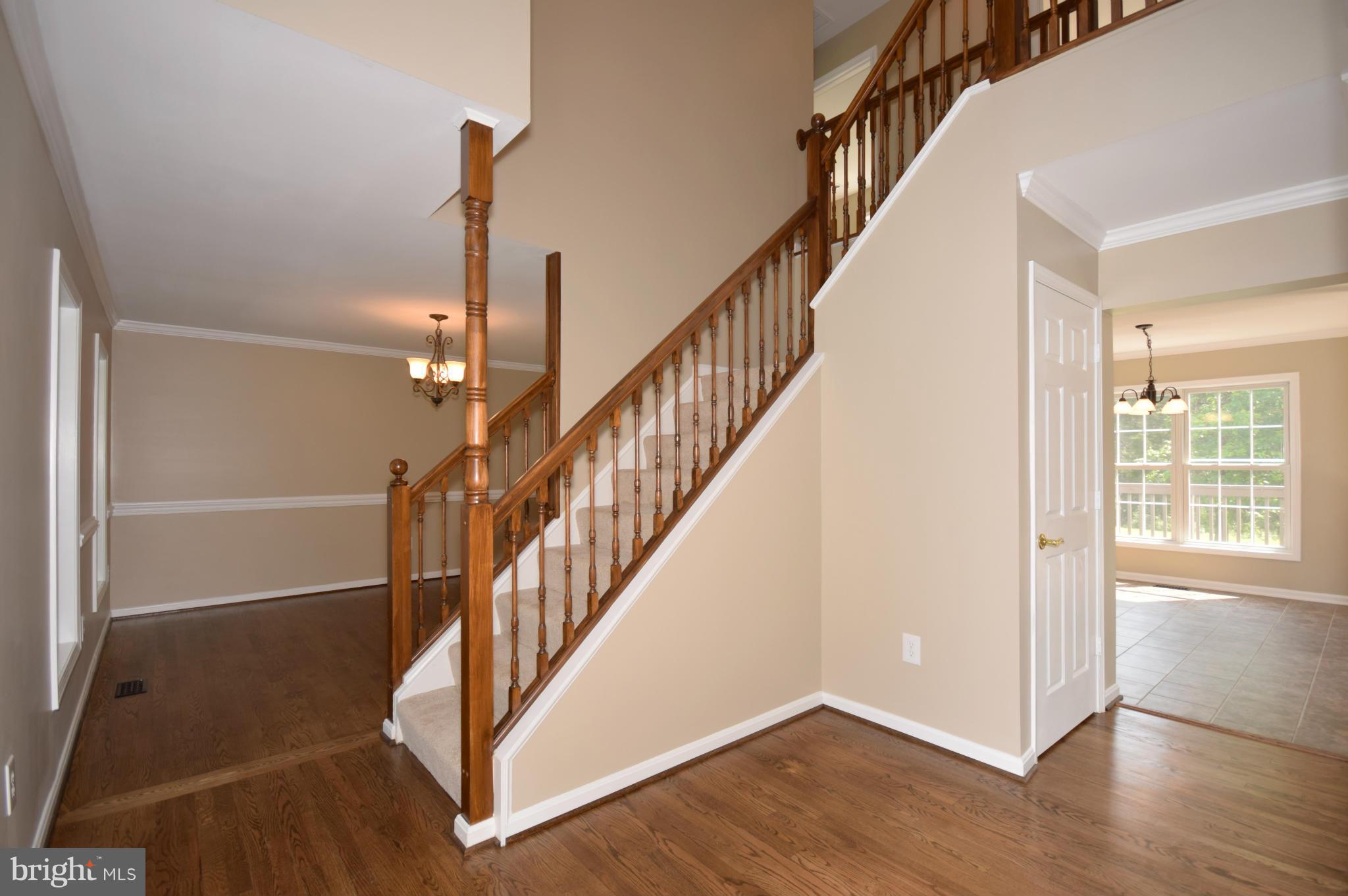 150 High Bluff Road Middletown, VA 22645 - Photo 12 of 30 a view of hallway with stairs and wooden floor