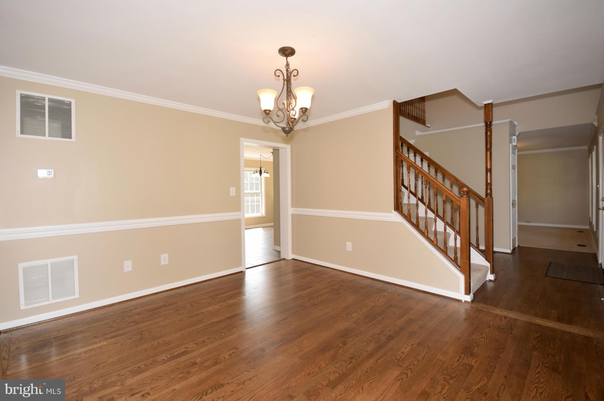 150 High Bluff Road Middletown, VA 22645 - Photo 13 of 30 a view of an empty room with wooden floor and a chandelier