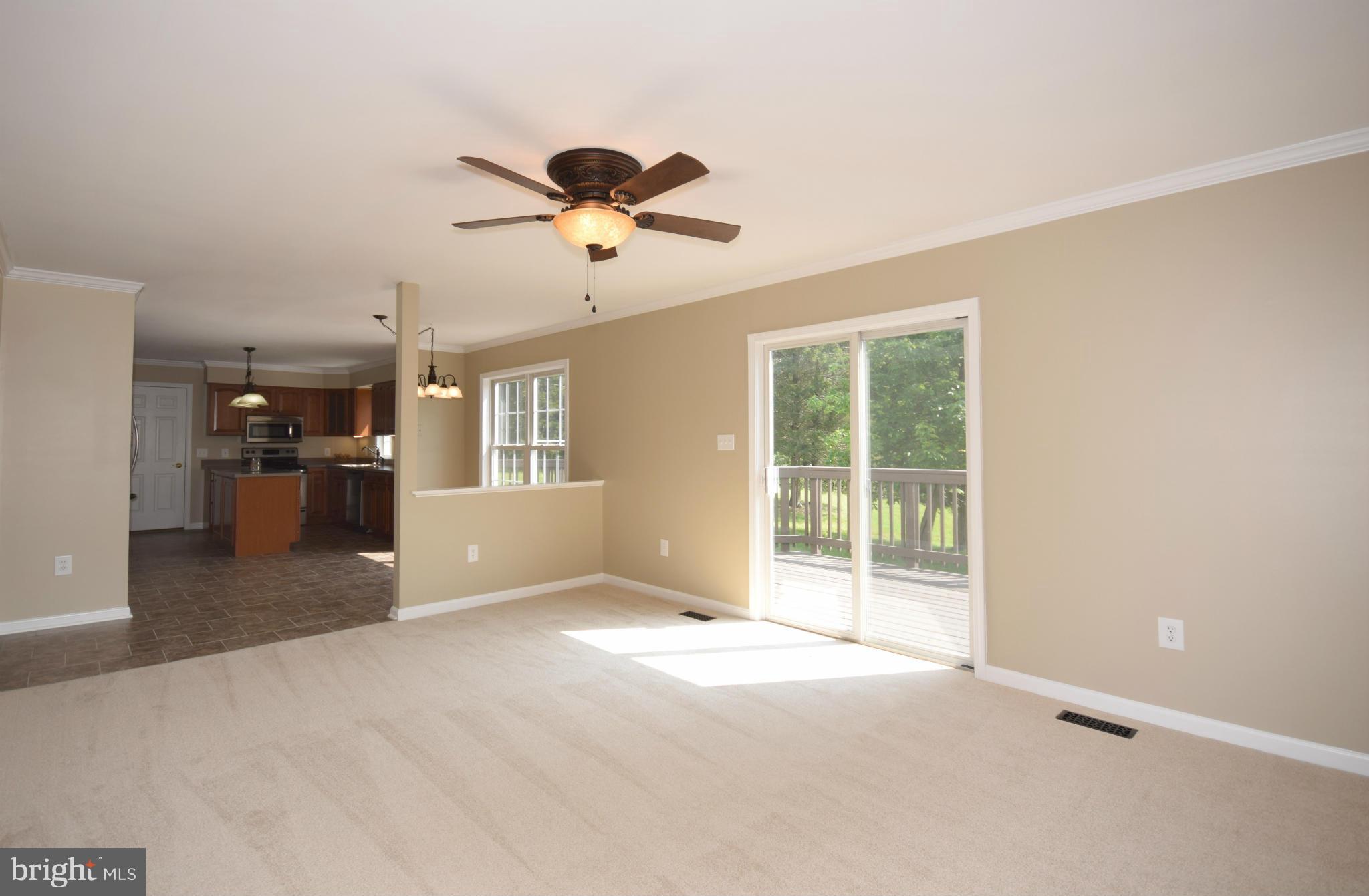 150 High Bluff Road Middletown, VA 22645 - Photo 14 of 30 a view of a big room with windows and chandelier fan