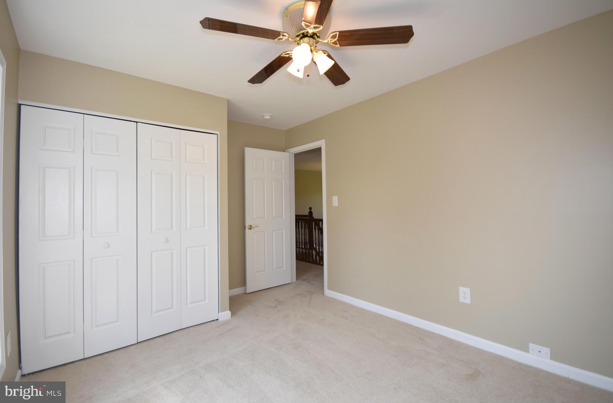 150 High Bluff Road Middletown, VA 22645 - Photo 16 of 30 an empty room with closet and a chandelier fan