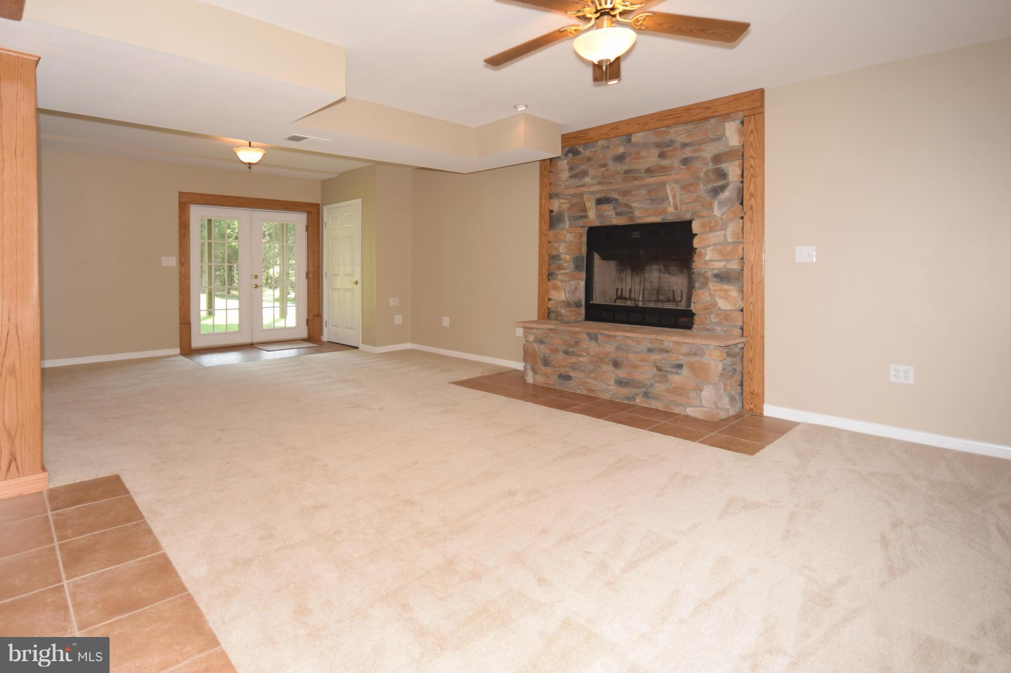 150 High Bluff Road Middletown, VA 22645 - Photo 23 of 30 a view of an empty room with chandelier fan and fire place