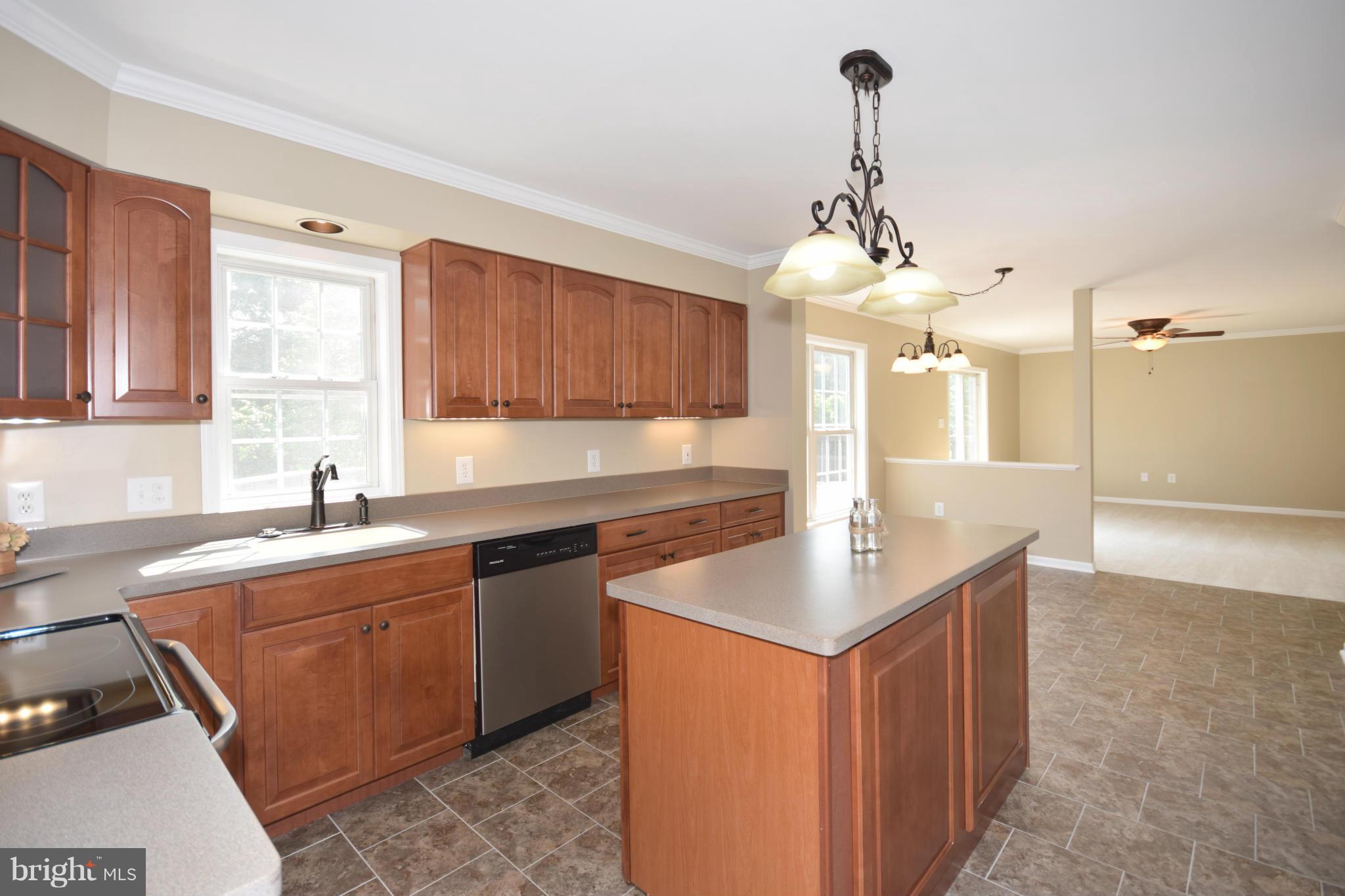 150 High Bluff Road Middletown, VA 22645 - Photo 8 of 30 a kitchen with granite countertop a sink stove and cabinets