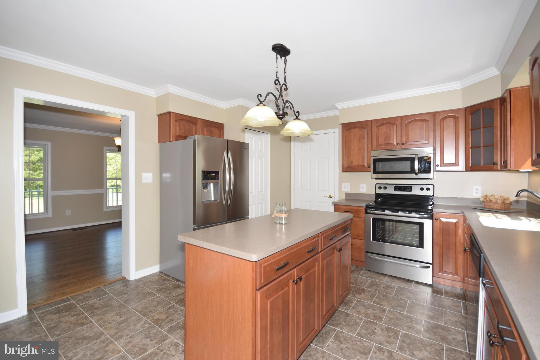 150 High Bluff Road Middletown, VA 22645 - Photo 10 of 30 a kitchen with stainless steel appliances granite countertop a sink stove and refrigerator