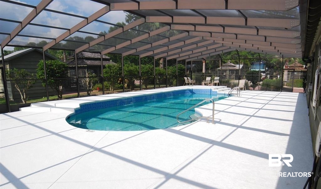 4650 Griffith Marina Road, Unit 22 Orange Beach, AL 36561 - Photo 19 of 25 View of swimming pool featuring a patio and screen enclosure