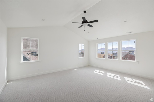 7189 South Sage Road, Unit 214 West Jordan, UT 84081 - Photo 15 of 29 Spacious room featuring vaulted ceilings, a ceiling fan, recessed lighting, and multiple windows with mountain scenery