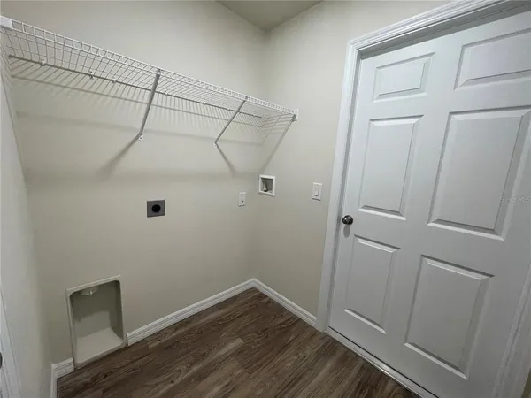 a view of a room with wooden floor