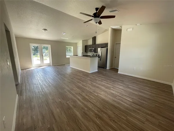 a view of a kitchen with a sink and wooden floor