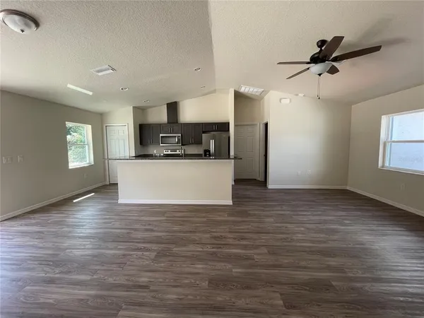 a view of a kitchen with microwave and cabinets