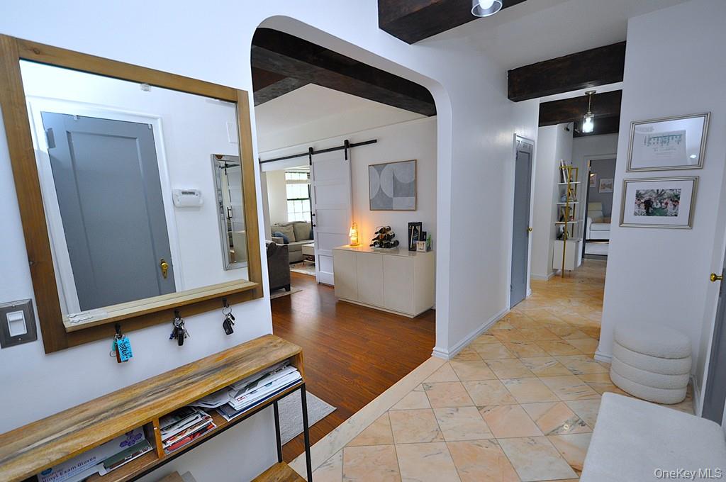 192 Garth Road, Unit TP Scarsdale, NY 10583 - Photo 32 of 43 A stunning marble-floored entry welcomes you into a light-filled home featuring charming courtyard views, soaring wood-beamed ceilings, gleaming hardwood floors, and an impressive eight oversized closets for exceptional storage.