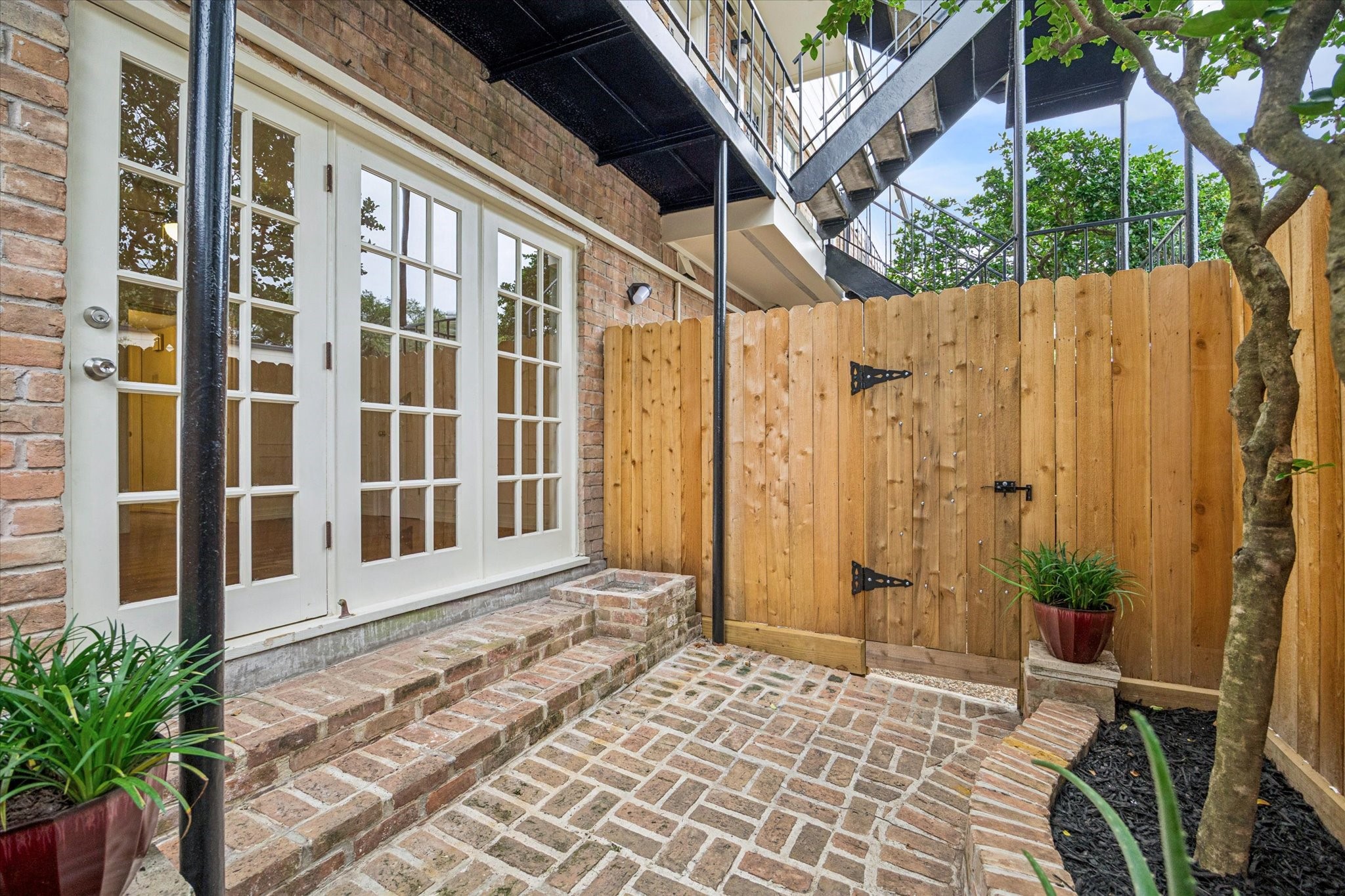 453 North Post Oak Lane Houston, TX 77024 - Photo 11 of 18 a view of a house with a wooden door and deck