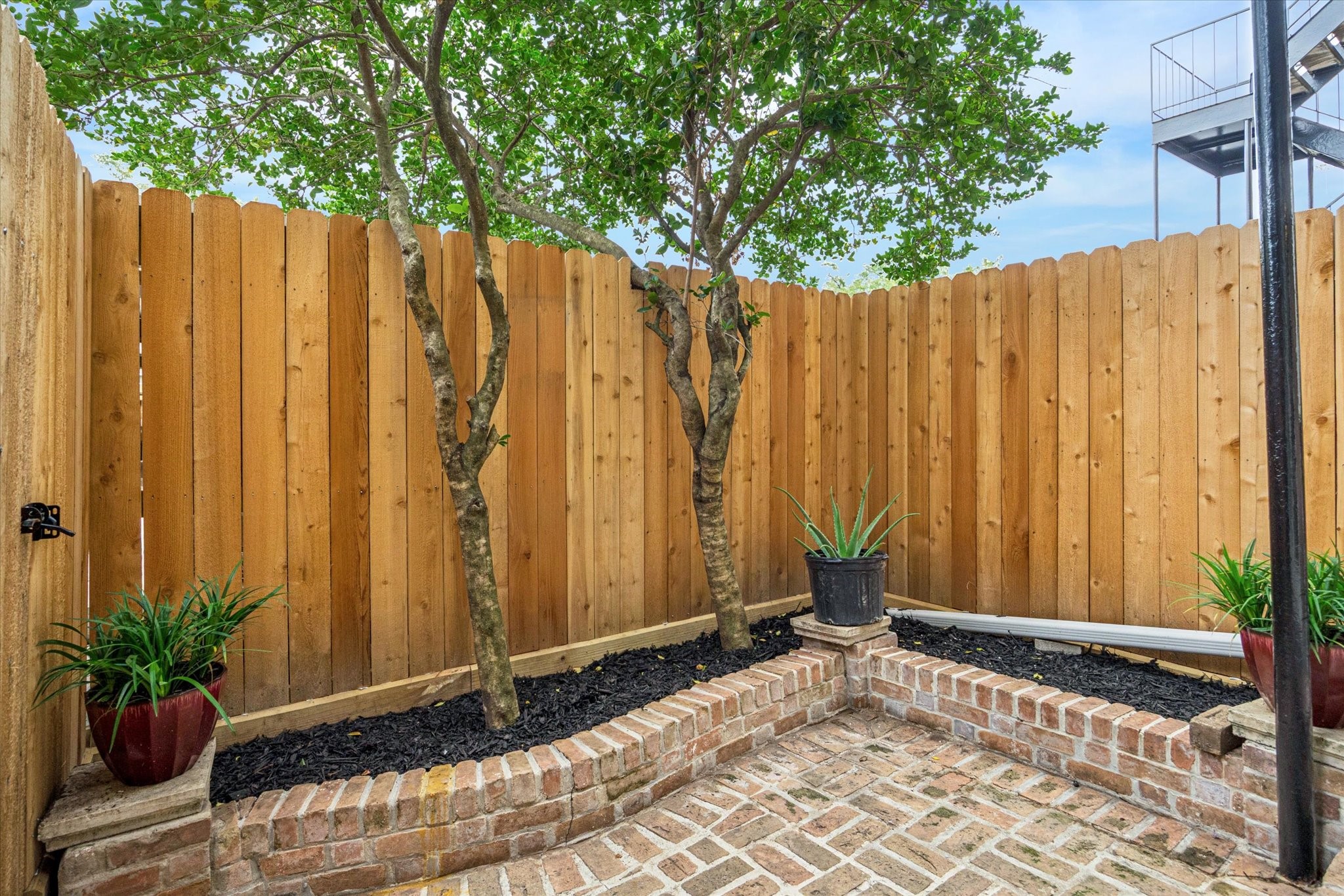453 North Post Oak Lane Houston, TX 77024 - Photo 12 of 18 a view of outdoor space with a wooden fence