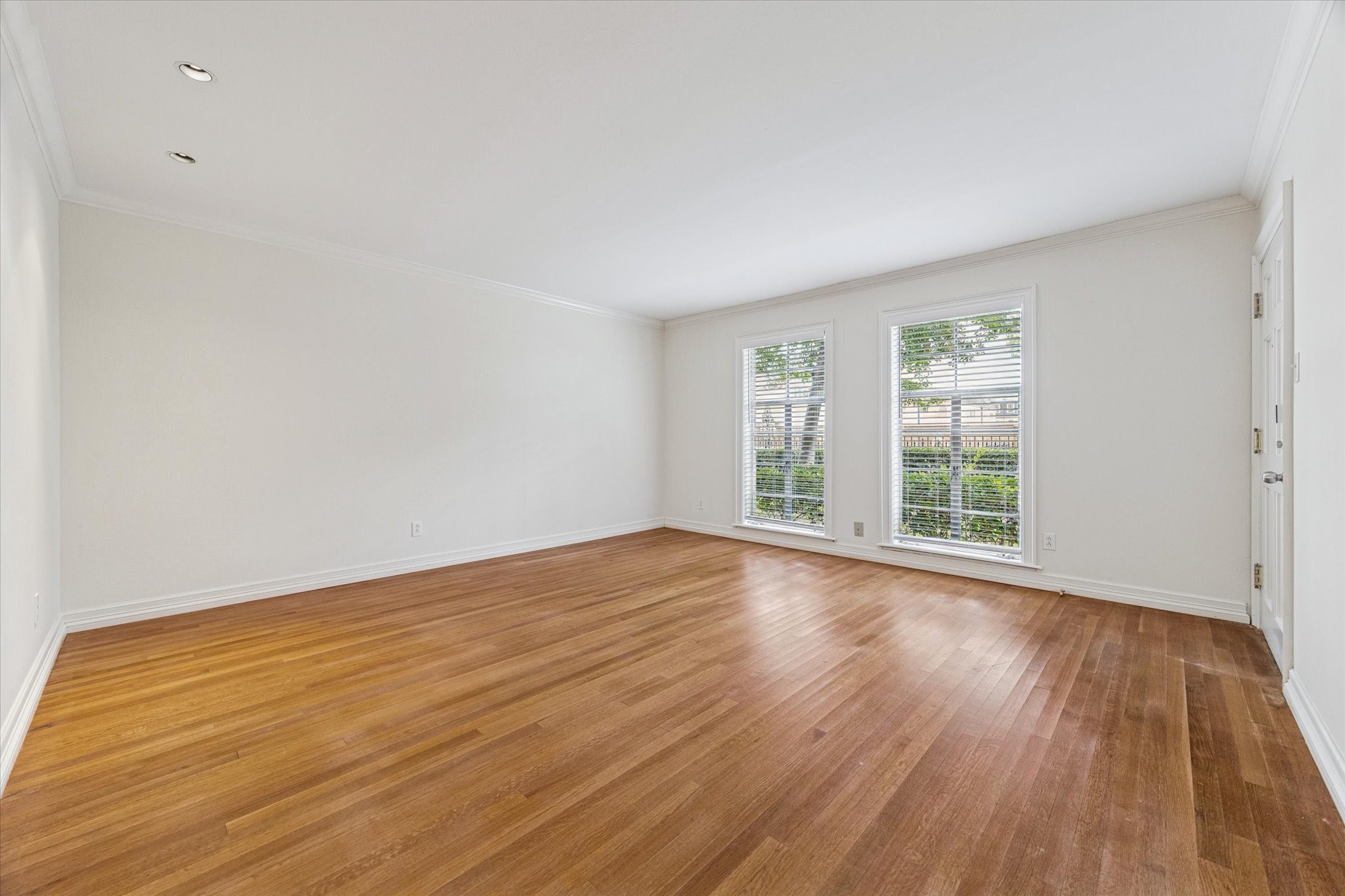 453 North Post Oak Lane Houston, TX 77024 - Photo 2 of 18 a view of an empty room with wooden floor and a window