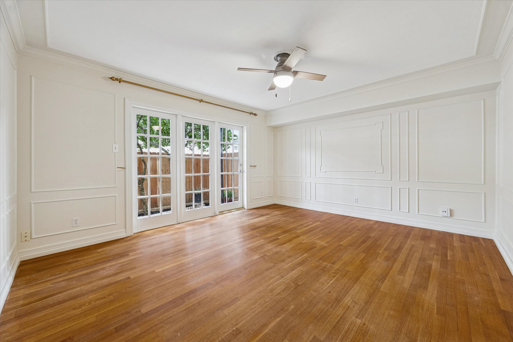 453 North Post Oak Lane Houston, TX 77024 - Photo 8 of 18 a view of an empty room with wooden floor and a window