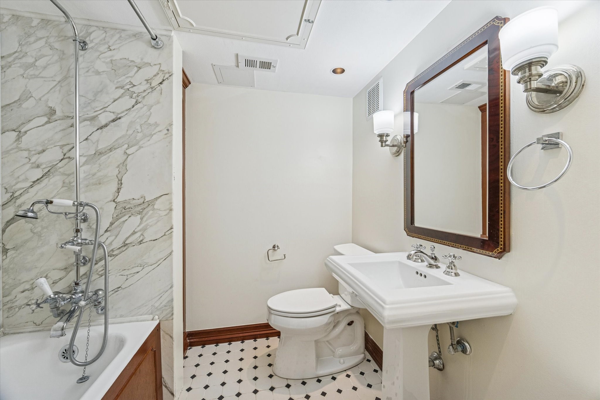 453 North Post Oak Lane Houston, TX 77024 - Photo 9 of 18 a bathroom with a sink a toilet and shower