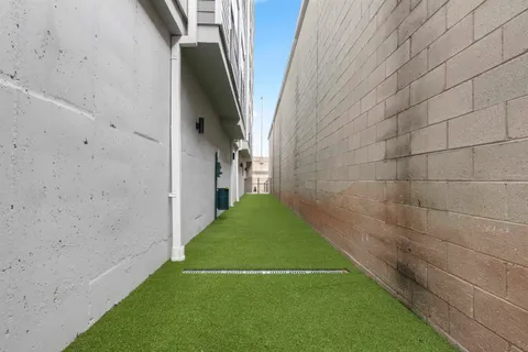 a view of a pathway both side of a house