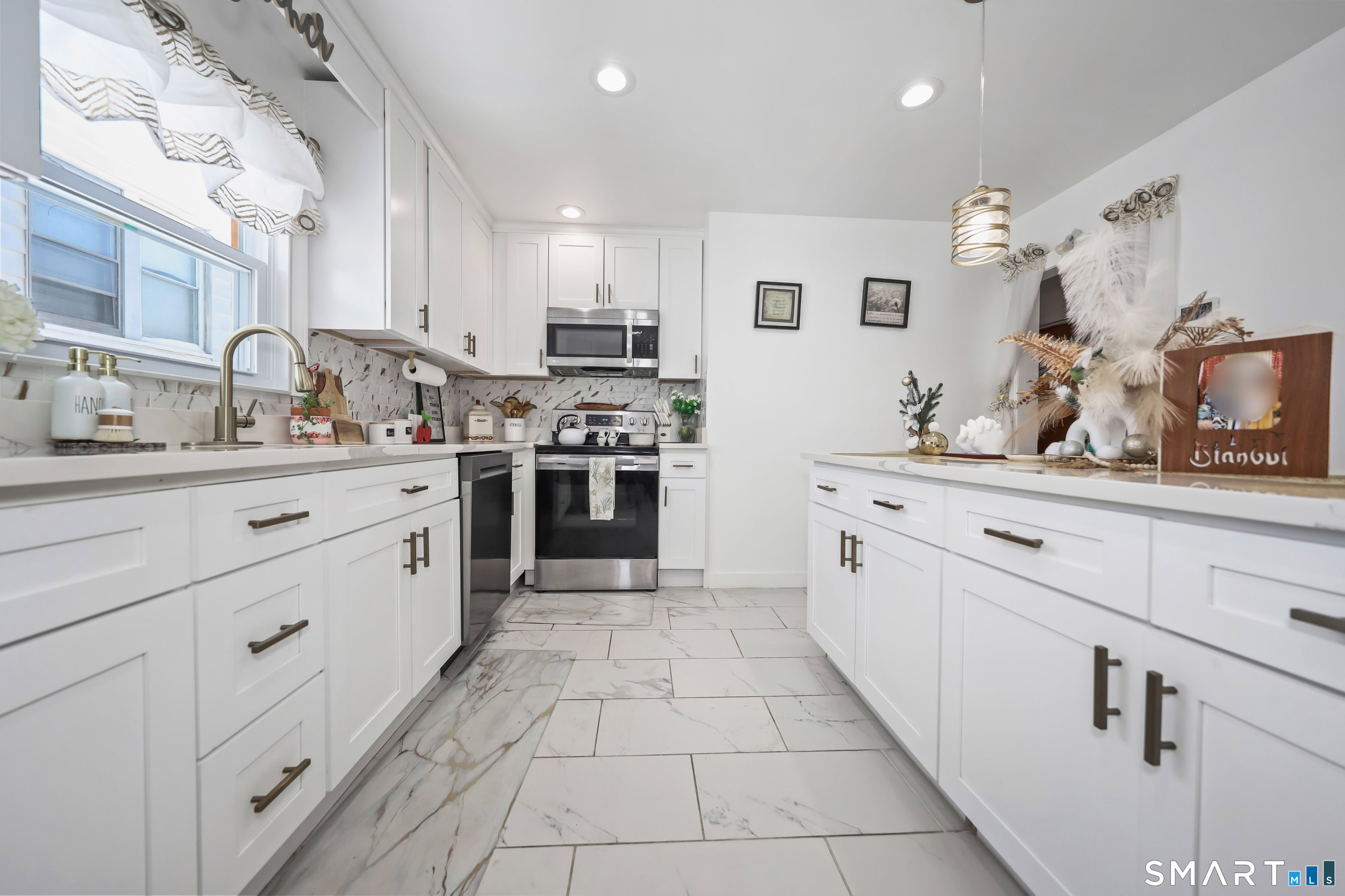 17 Rosedale Avenue Waterbury, CT 06705 - Photo 6 of 20 a kitchen with stainless steel appliances kitchen island granite countertop a sink and cabinets