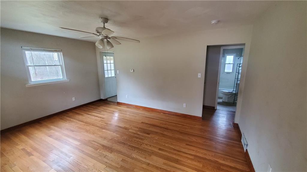 125 Michael Road Cheswick, PA 15024 - Photo 8 of 14 a view of empty room with wooden floor and fan