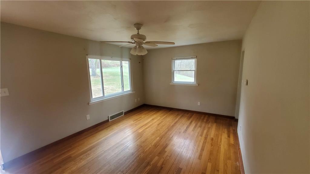 125 Michael Road Cheswick, PA 15024 - Photo 9 of 14 a view of an empty room with a window and wooden floor