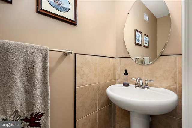 a living room with furniture and a painting on the wall