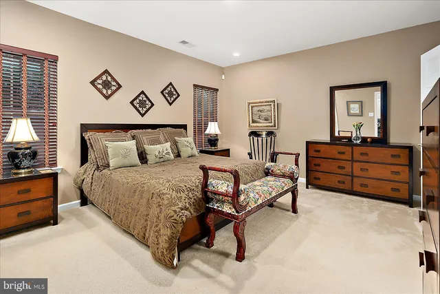 a spacious bedroom with a bed and a chandelier