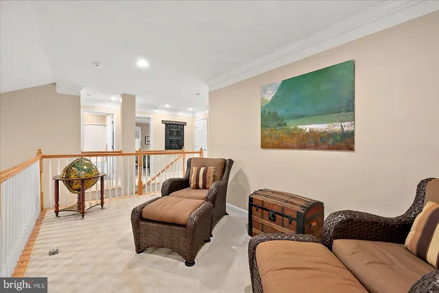 a living room with a couches and kitchen view